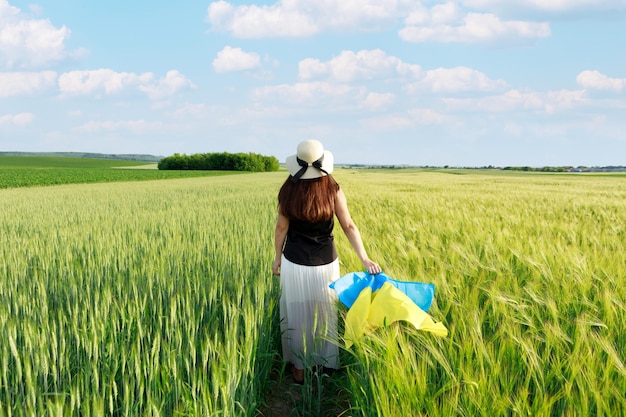 Woman with Ukrainian flag in wheat fieldHappy boy celebrating Independence Day