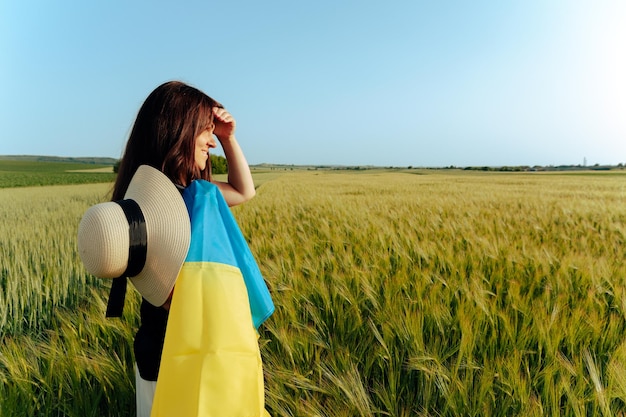 Woman with Ukrainian flag in wheat fieldHappy boy celebrating Independence Day