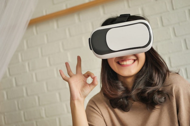 Woman with vr headset giving ok hand gesture