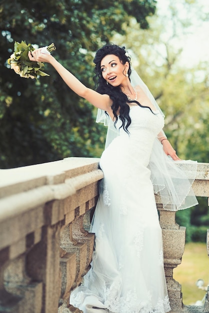 Woman with wedding bouquet Woman with flowers on balcony