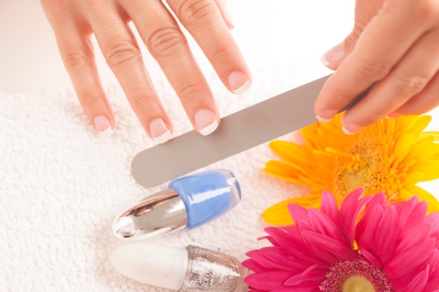 Woman with well manicured nails on white