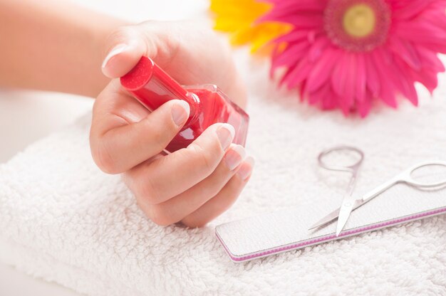 Woman with well manicured nails on white