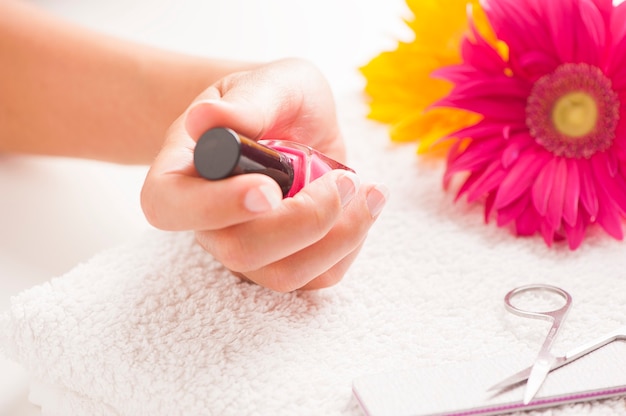 Woman with well manicured nails on white