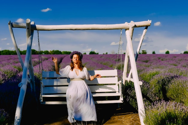 Woman with wreath of flowers in lavender field