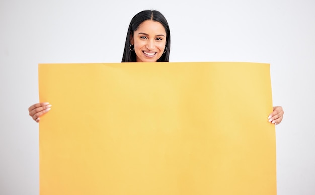 Woman with yellow mockup poster for advertising marketing and product placement on blank cardboard Happy smile and a model in studio with sign board in hands for text brand or logo advertisement