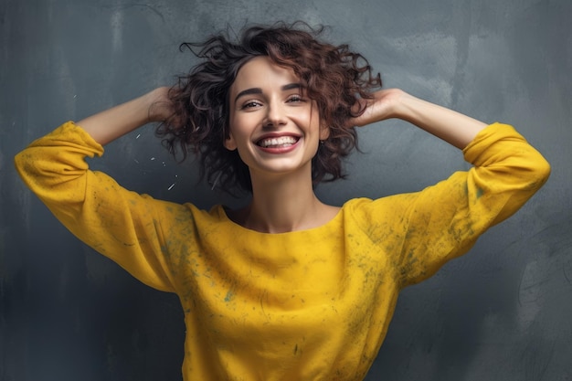 A woman with a yellow sweater and a yellow sweater smiles and smiles.