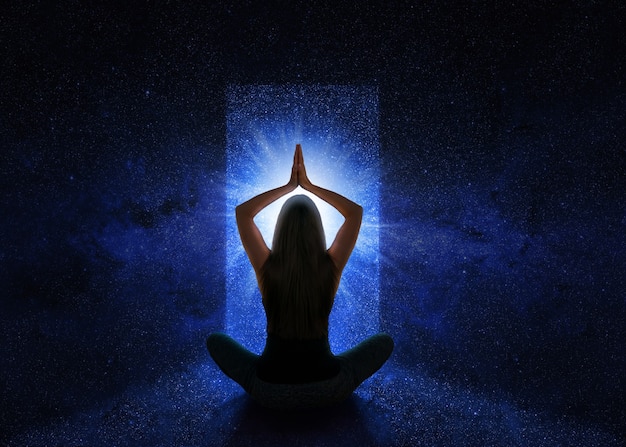 Woman with yoga pose in front of the universe