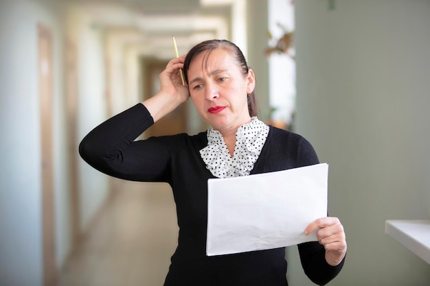 Woman at work with papers The employee solves the problem