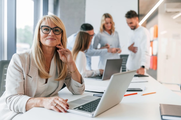 Woman working by using laptop Group of professional business people is in the office