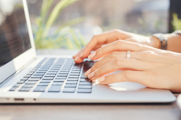 Woman working at a computer in a cafe