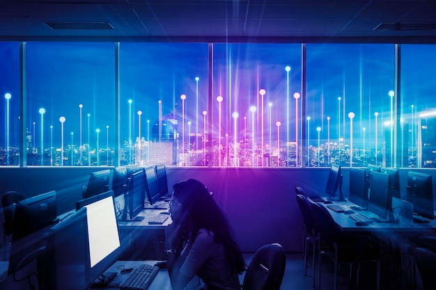 Woman working at computer lab with futuristic city background