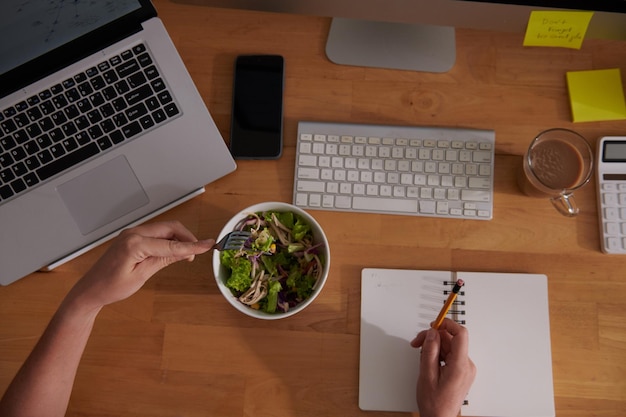 Woman Working and Eating Salad