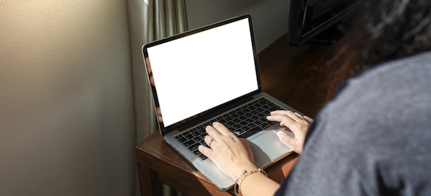 Woman working from home on bed E learning home isolation auto quarantine woman working on laptop computer while sitting at living room