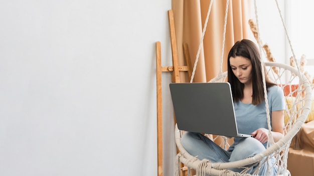 Woman working at home on laptop with copy space