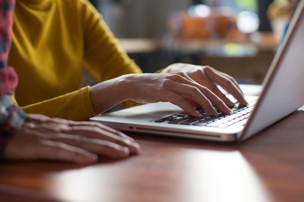 Woman working at home office hand on keyboard