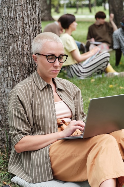 Woman working on laptop outdoors