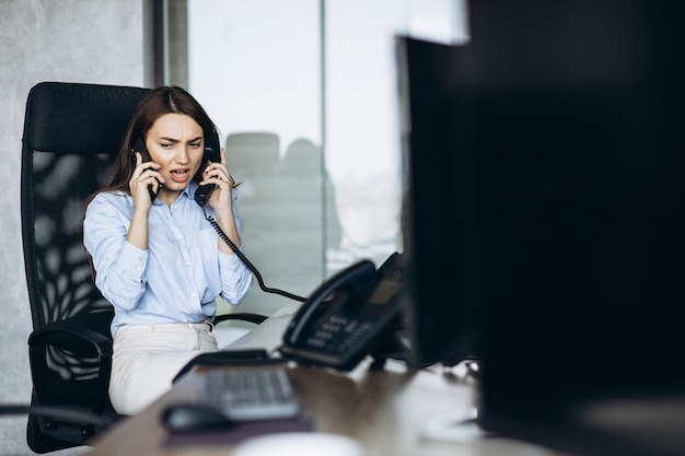 Woman working at the office on the exchange and using phone