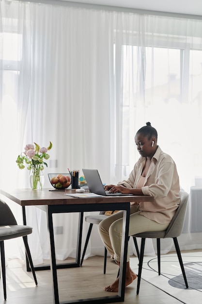 Woman working online on laptop at home