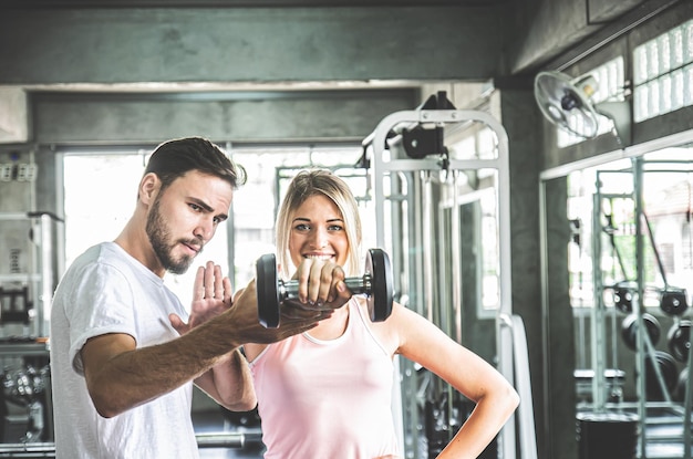 Woman working out in sport fitness centerCouple workout at Gym