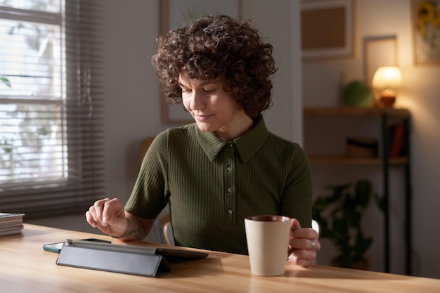 Woman working on tablet pc at home