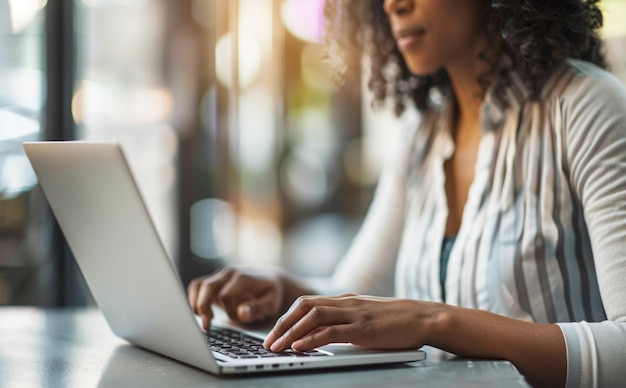 Woman working using laptop online checking email and planning internet while sitting in office al