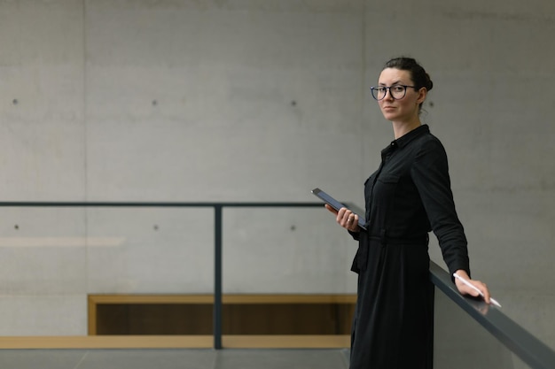 Woman working using tablet pc in minimalist office workspace