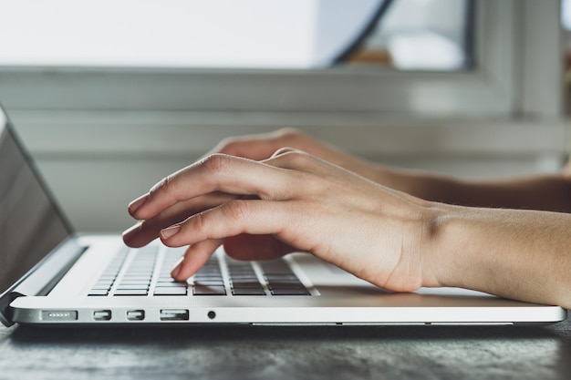 Woman working with laptop placed on the black desk