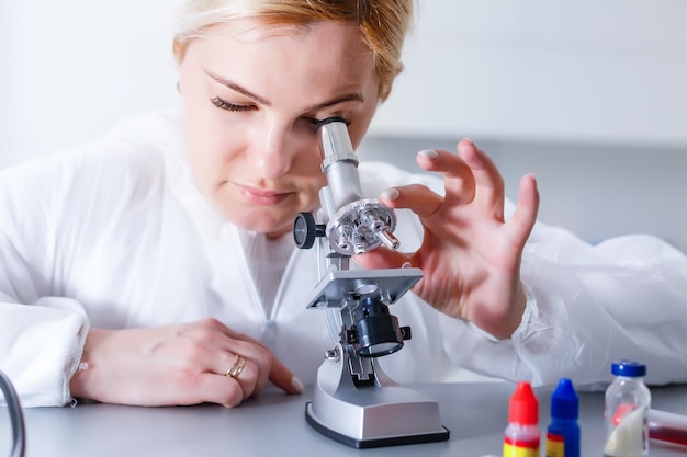 Woman working with a microscope in lab