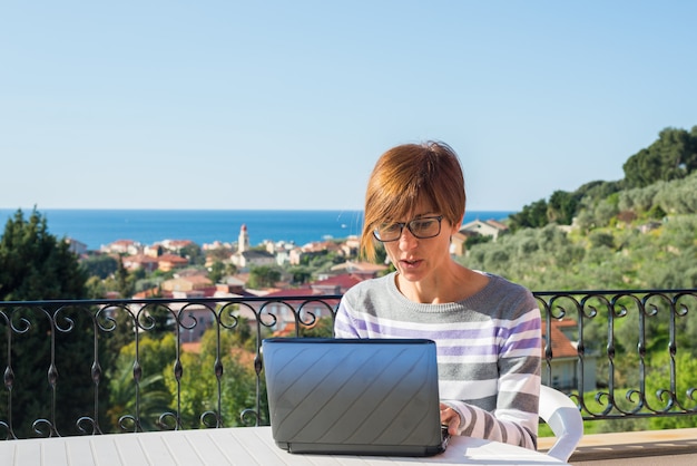 Woman working with netbook outdoors