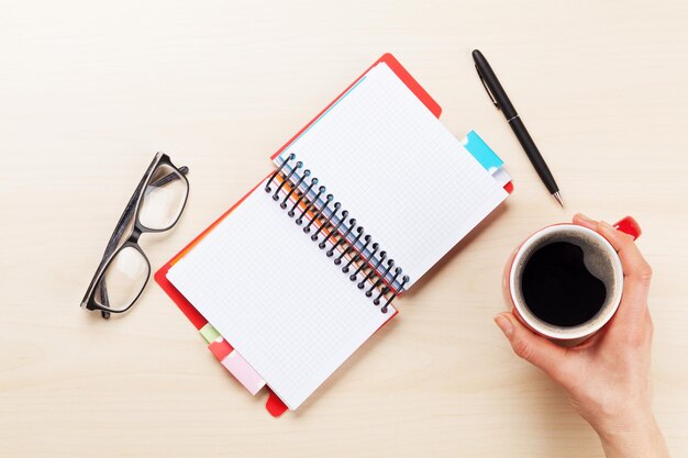 Woman working with pen and coffee