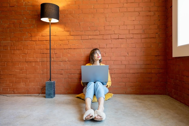 Woman works on laptop at home