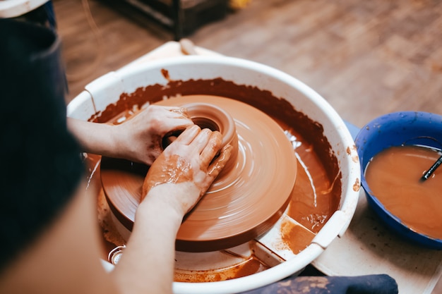 Woman works on a pottery wheel