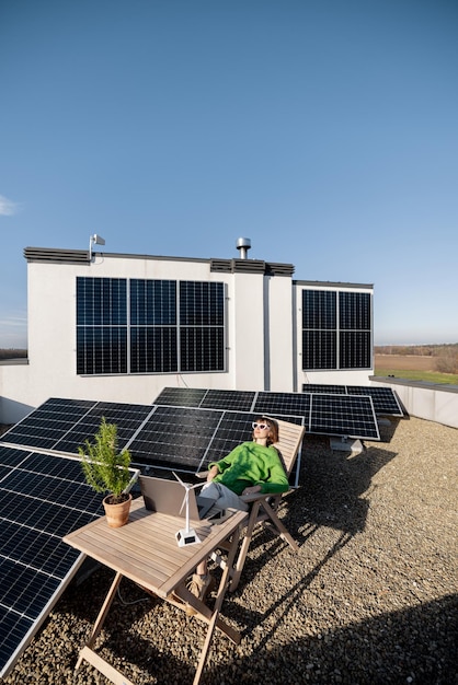 Woman works on a rooftop with a solar power plant