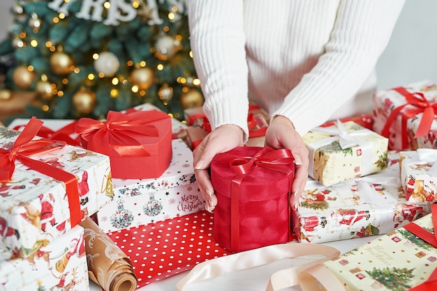 Woman wrapping christmas gift boxes