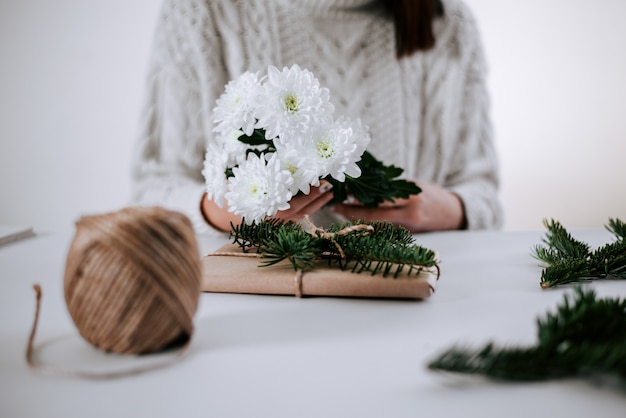 Woman wrapping gift for Mother's day, Valentine's Day or birthday.