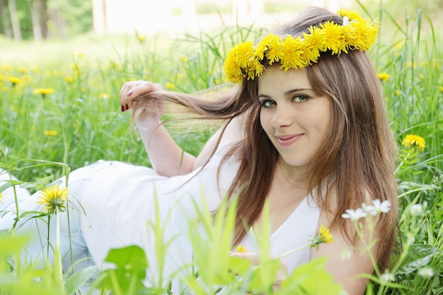 Woman at the wreath lying on the grass