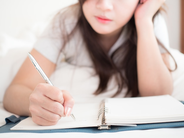 woman write diary in bedroom