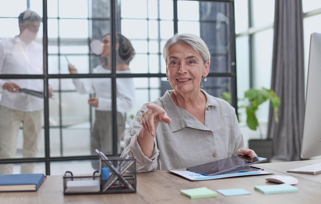 Woman writes notes working at the office at the computer