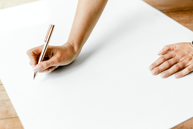 Woman writing on a chart paper