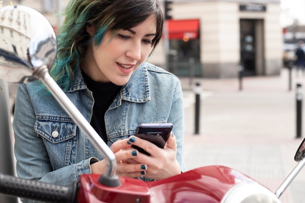 woman writing a message on her cell phone in town