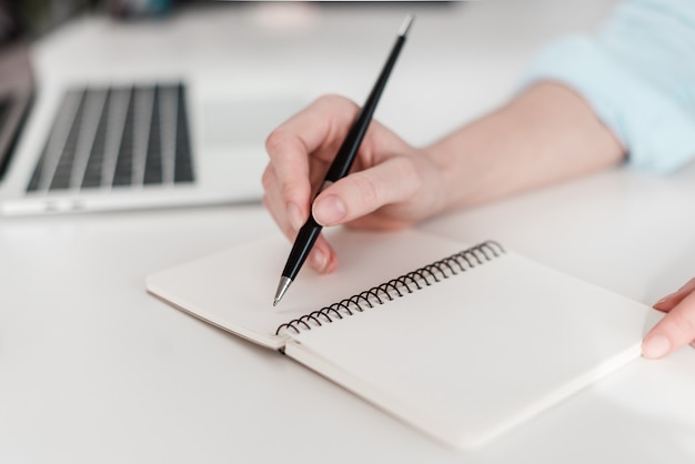 Woman writing in notebook