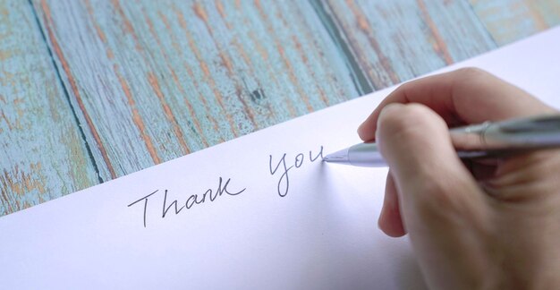 Woman writing thank you on card or paper