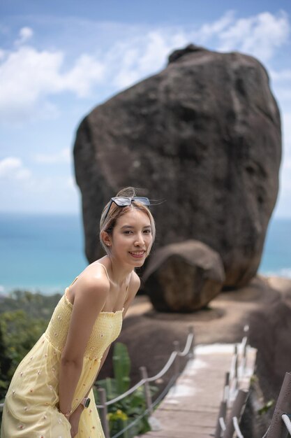 Woman in yellow dress overlap with ocean view background