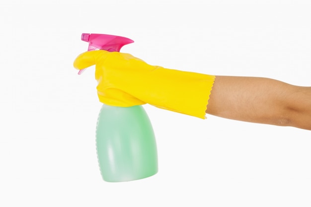 Woman in yellow rubber gloves holding window cleaner