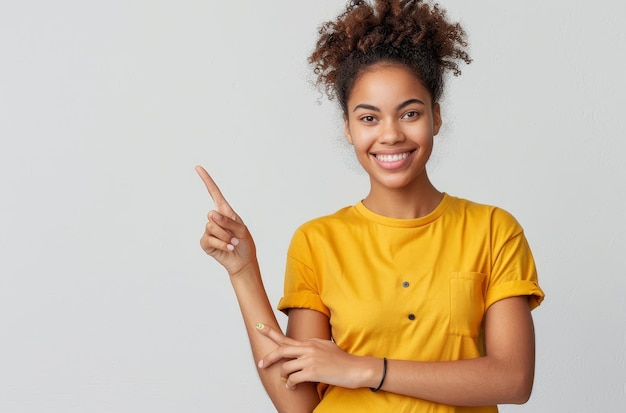 a woman in a yellow shirt is pointing at the camera