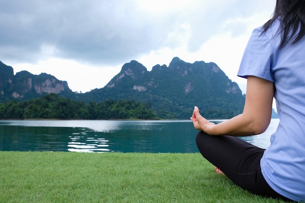 Woman Yoga and Meditating - relax in nature