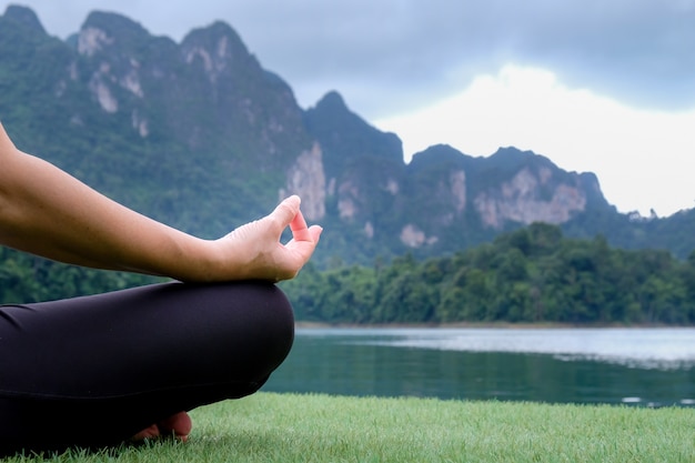 Woman Yoga and Meditating - relax in nature