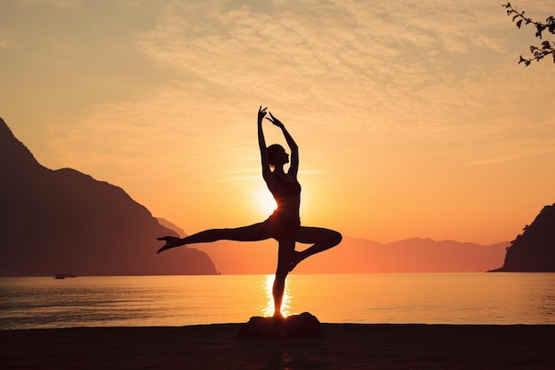 a woman in a yoga pose on a beach with the sun behind her