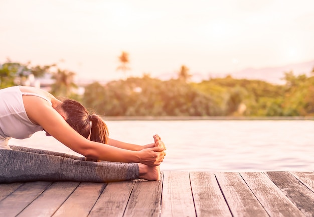 Woman yoga with nature surrounding background. Concept of healthy and relaxation.