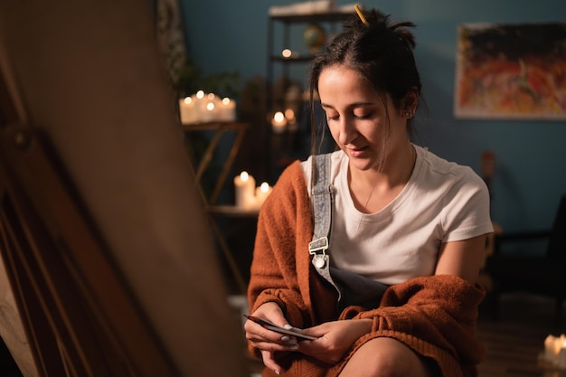 A woman of young age sits in her homespun clothes in the living room